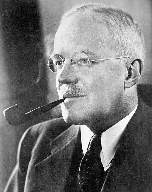 Historical portrait of Allen Dulles holding a pipe